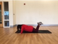 person in the modified push up position with knees on floor and arms bent 