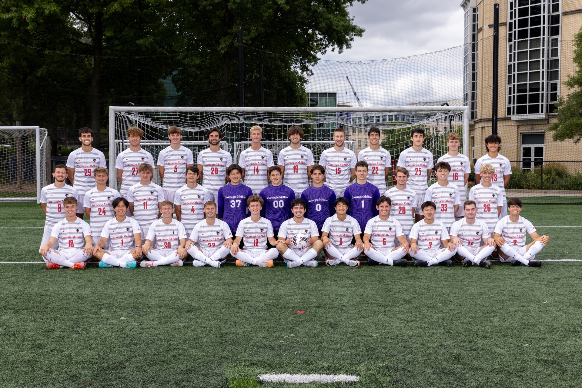 team photo of men's soccer team standing and sitting in three rows