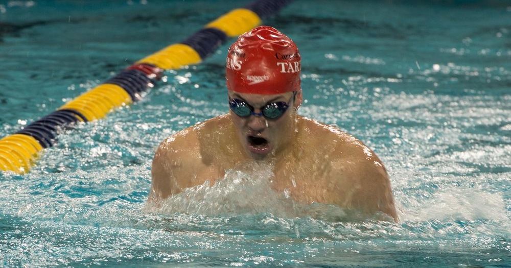 men's swimmer with red cap doing breaststroke