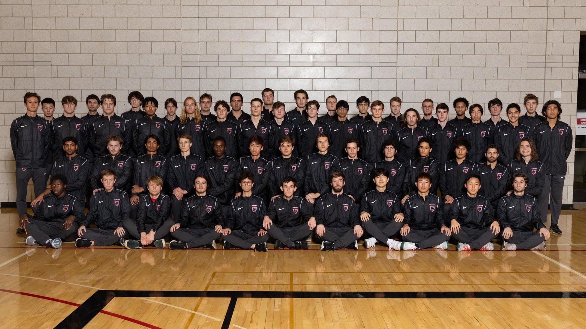 team photo of men's track and field team consisting of more than 60 people
