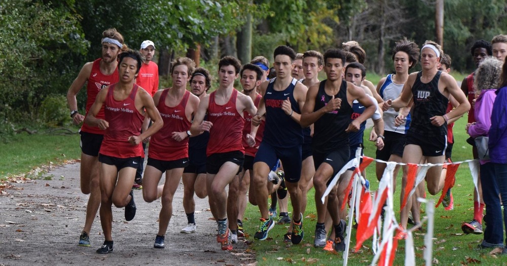 men's cross country runners turning a corner during a race