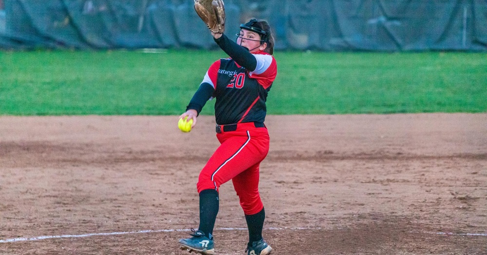women's softball pitcher in mid motion