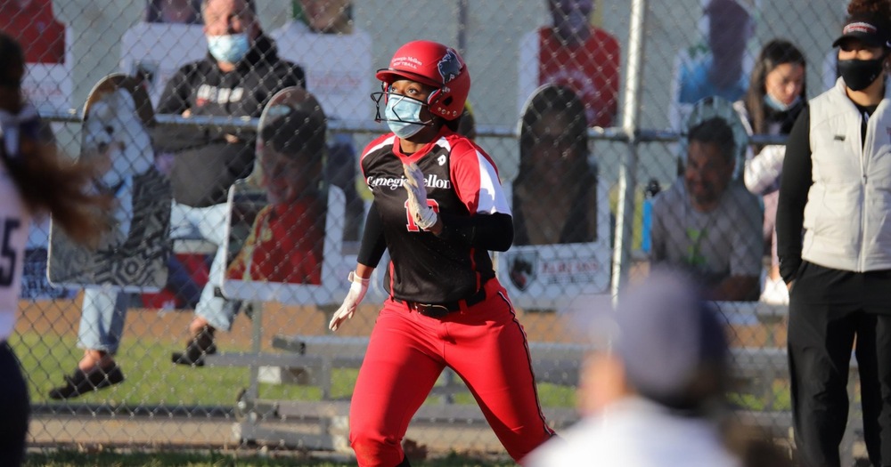 softball player following a hit while running to first