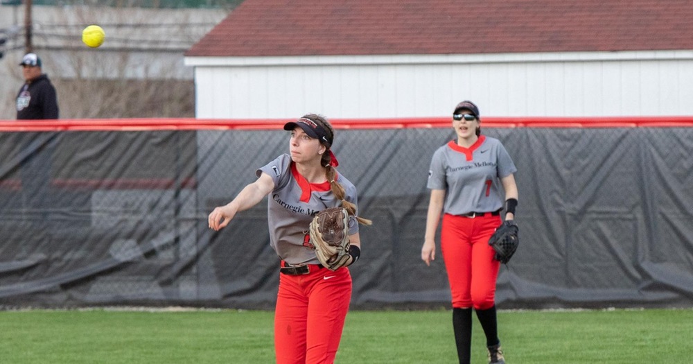 women's softball player throwing a ball in from the outfield