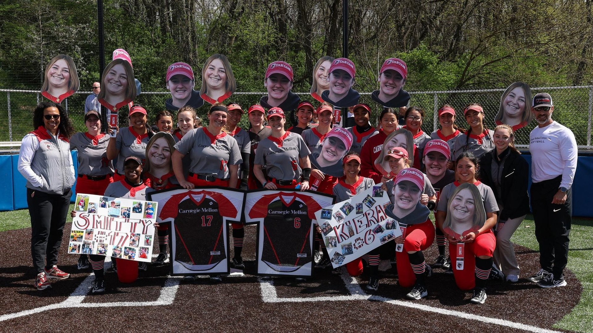 group gathering of women's softball players with signs and photos