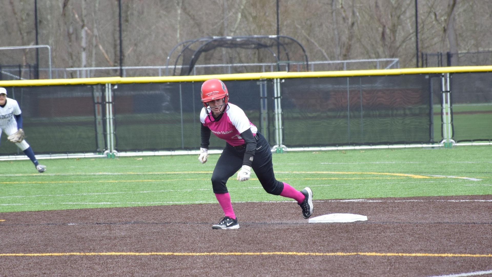 women's softball player leading off second base