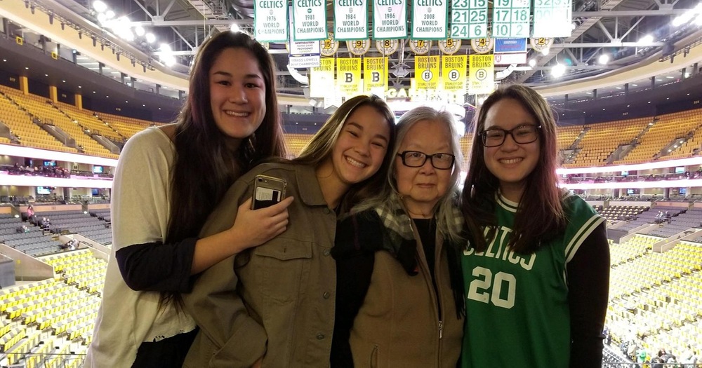 Alex Moy with her younger sisters and grandmother at a Celtics game.