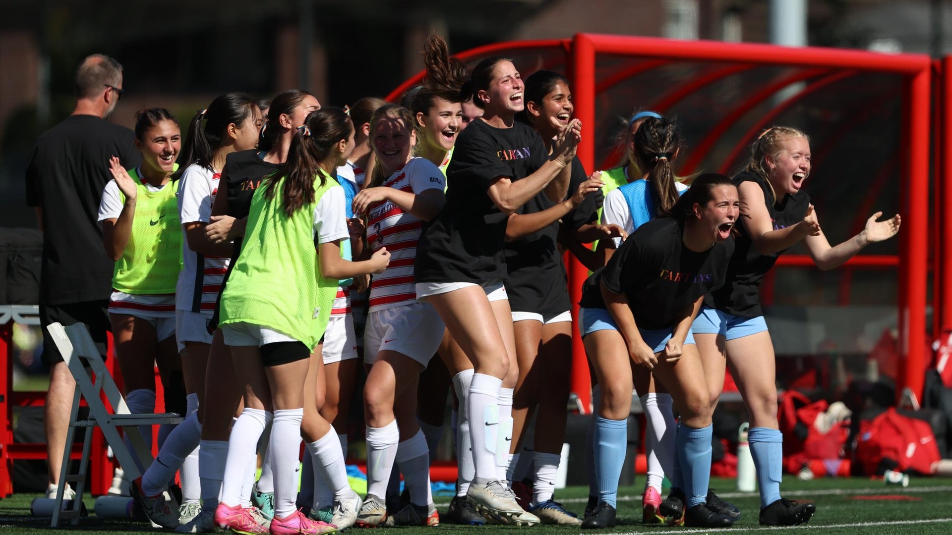 group of women celebrating by screaming and clapping