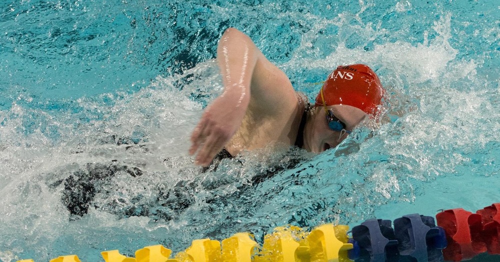 women's swimmer in red cap doing freestyle