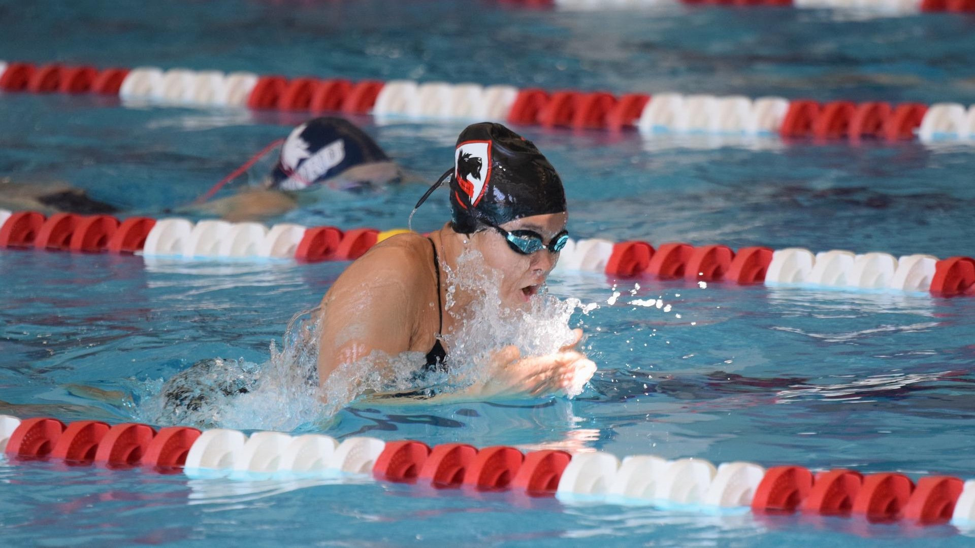 women's swimmer in breaststroke motion