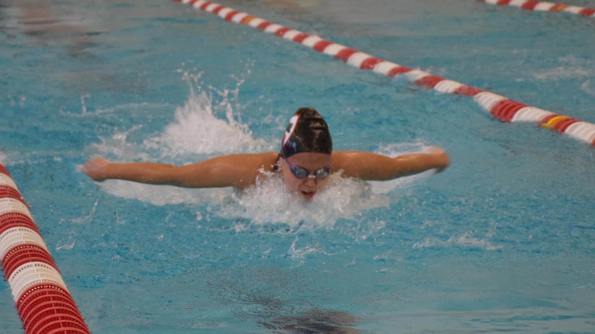 women's swimming doing butterfly stroke