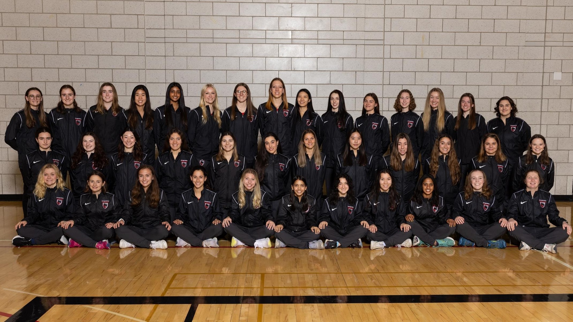 team photo of women's track and field team consisting of more than 40 people