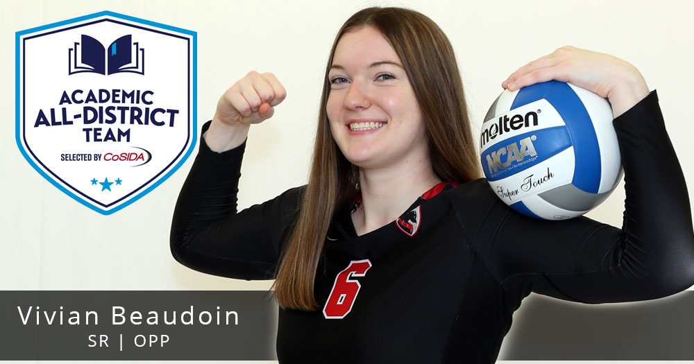 volleyball player wearing black jersey standing with ball between hand and shoulder with Academic All-District logo