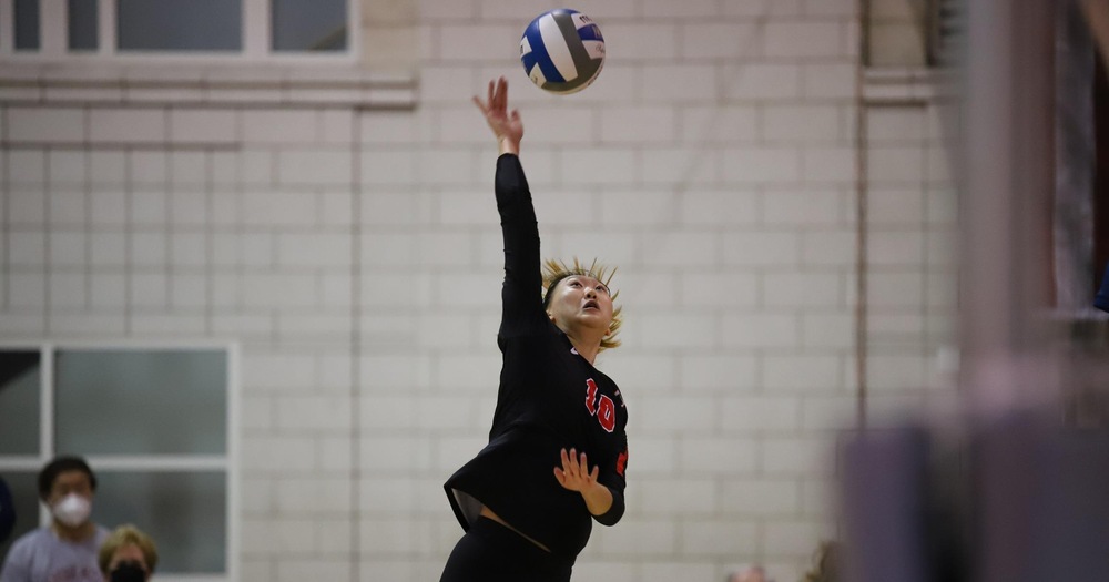 women's volleyball player hitting the ball for a kill attempt