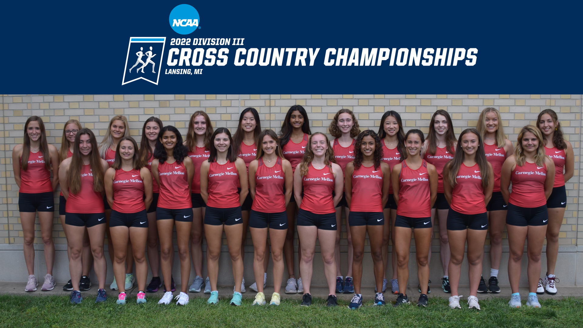 women's cross country team standing in two rows with NCAA Cross Country Championships logo