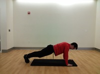 side view of man in high plank position with arms extended