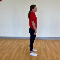 side profile of person standing straight with arms at side with shoulders rotated up