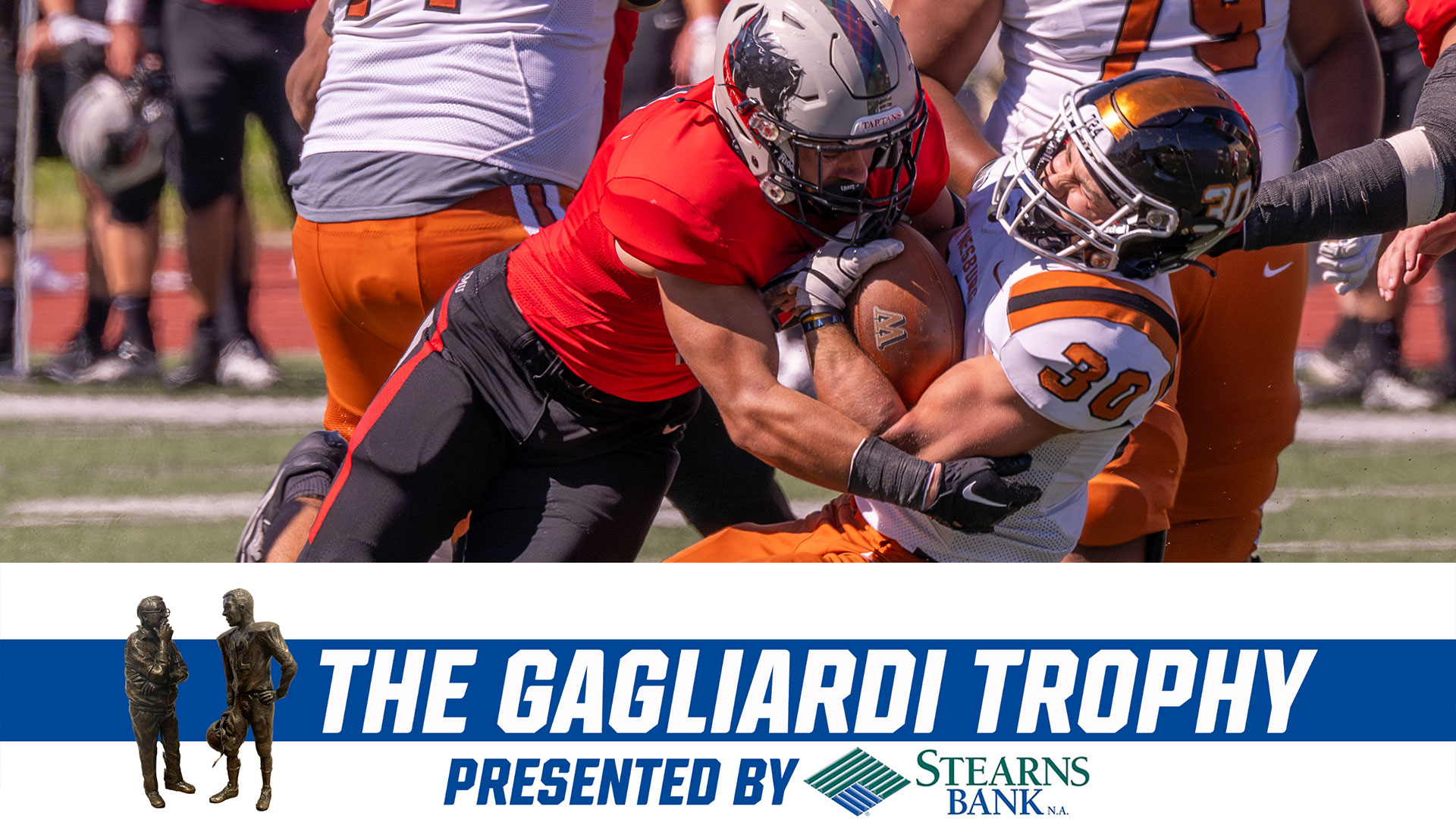 football player wearing red jersey and black pants tackles player wearing white jersey and orange pants with text readying The Gagliardi Trophy Presented by Stearns Bank